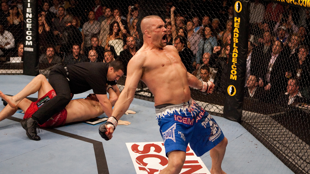 Chuck Liddell doing his iconic celebration in the octagon.