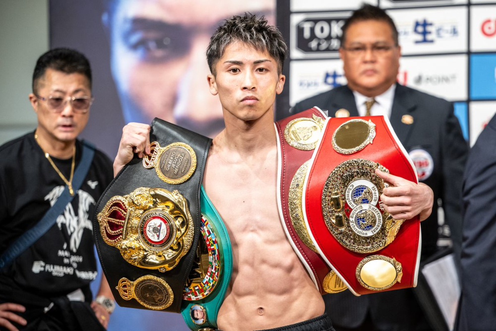 Naoya Inoue poses with his belts.