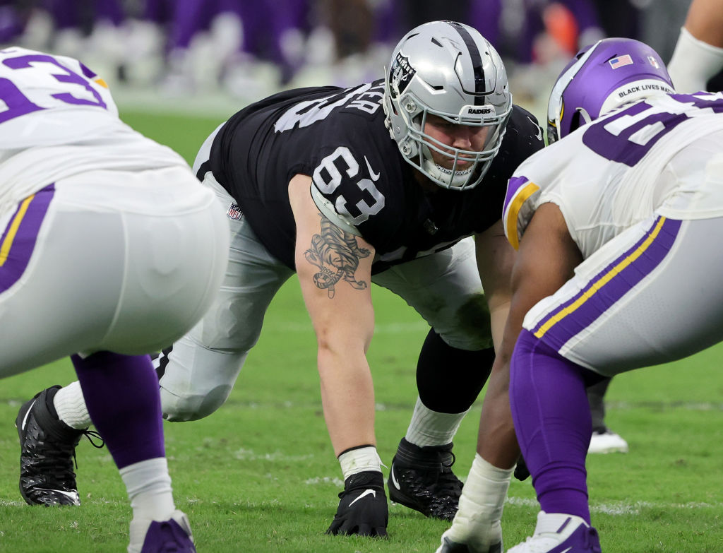 Jogadores do Minnesota VIkings e do Las Vegas Raiders alinhados na linha de scrimmage antes de um snap, em um jogo da NFL.