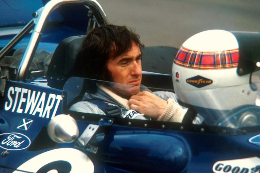 One of the best F1 drivers of all time, Jackie Stewart, sat in his car on the grid