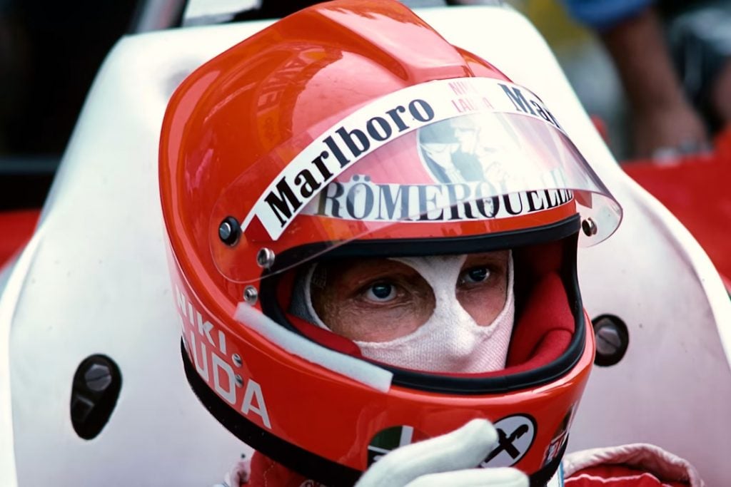 Niki Lauda with his helmet on in an F1 car two races after his horror crash